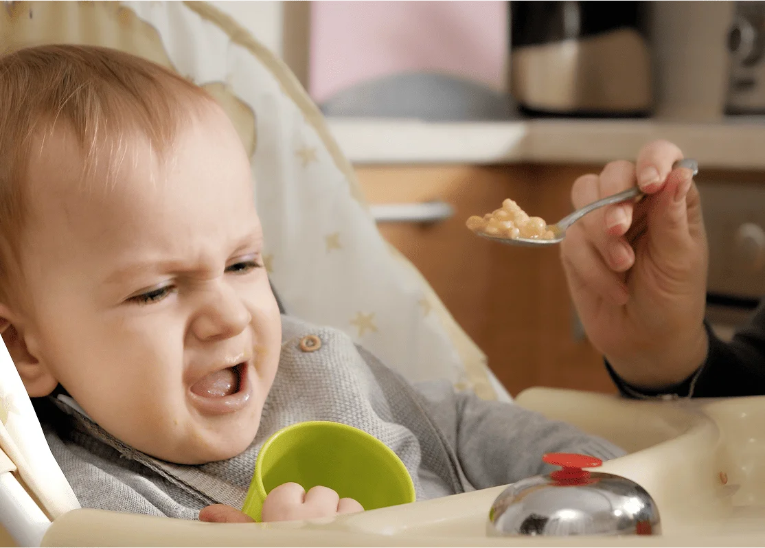 Mom holding baby in arms at home